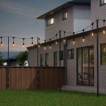 10ft string light pole with a rust-resistant black finish, supporting festive outdoor string lights in backyard setting.